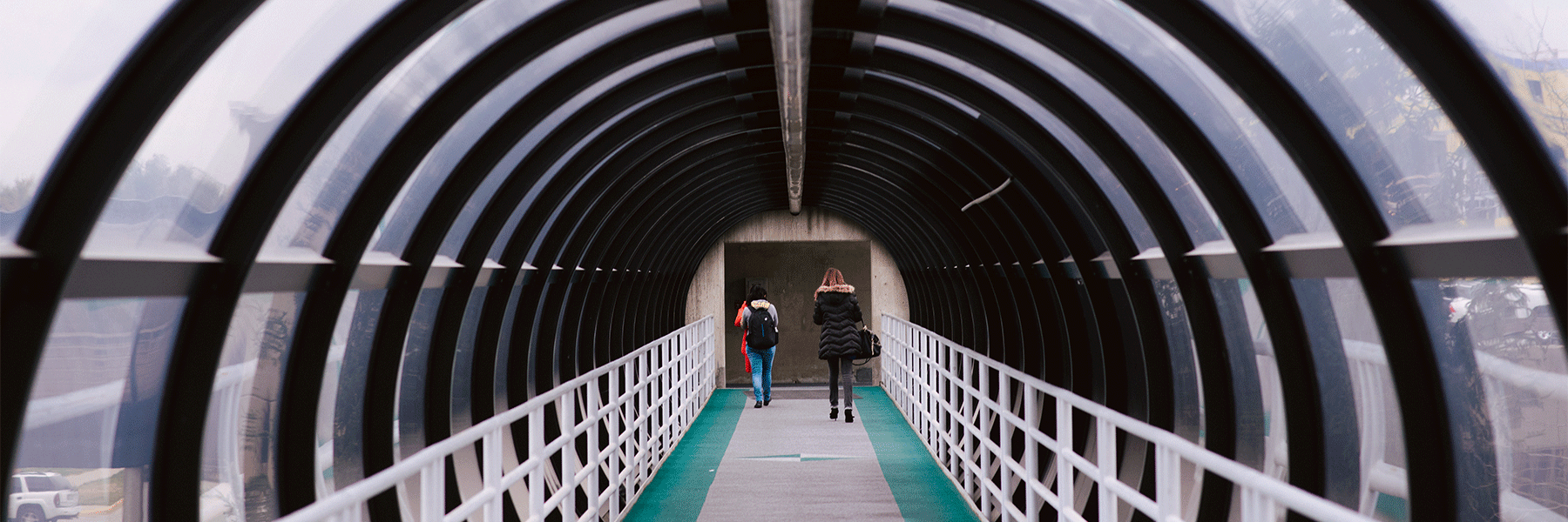 Two students walking through one of the gerbil tunnels.
